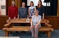 HAND-carved tribute . . . the bench at Saddleworth School in memory of former teacher John Atack. Sitting on the bench is John's widow Pam who is pictured with wood artist Simon Hodgson, John's daughters Christine Vucak, Sue Mair and organiser Kathy Wander