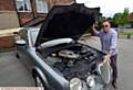 Mark Elliott, landlord at the Dog Inn, Chadderton with his crocked Jaguar