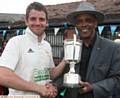 JUST THE JOB . . . Heyside captain Ryan Barnes receives the Tanner Cup from PCL president John Holder