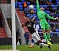 HEADS UP . . . Athletic front man Craig Davies challenges Cameron Borthwick-Jackson and goalkeeper Kieran O'Hara in last night's friendly.