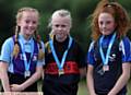 PODIUM PLACES . . . Year Sevens 1,500m champion Ella Rigby (Failsworth) is flanked by runner-up Lia Robinson (left Newman College) and Alyssa Donohue (Waterhead Academy)