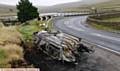 The burnt-out shell of a car left on Huddersfield Road, Denshaw near New Years Bridge Reservoir.