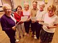 Dr Kershaw's Oldham choir members with choir master Paul Firth