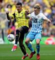 LEFT-BACK RAIDS . . . Oxford United's Marvin Johnson (left)