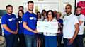 WE did it . . . Paul Crossley (front, left) and Afraz Ahmed (front, right) presented a cheque for £2,310 to community fundraiser Ali Taylor (front, centre) at Dr Kershaw's Hospice