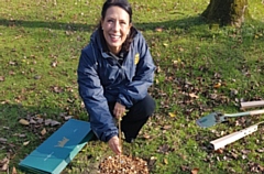 MP Debbie Abrahams inspecting one of the saplings in Alexandra Park