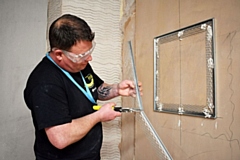 Stuart Smith learning plastering techniques at Hopwood Hall College