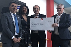 Oldham Business Awards steering group members Kashif Ashraf, Dawn Torrington and Martyn Torr present a cheque to Mike Doran (right), chief executive of Mahdlo