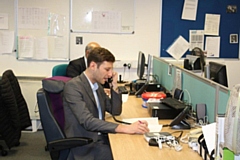 Oldham Council leader Sean Fielding talks to a resident on the phone