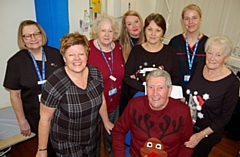 Pictured is Tommy Flannagan (bottom of picture) with his wife Mavis (to the immediate right of him) plus the team at the Medlock Medical Practice 