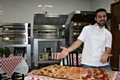 Have a go at the charity Pizza Challenge at Linda Lewis Kitchens' Oldham base. Pictured is chef Fabio Aurelio.