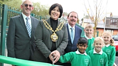Cllr Ginny Alexander (Mayor of Oldham) and Kritish (Greenfield Primary School pupil) cutting a ribbon to mark the official opening of Greenfield Primary School, with Ceri Davies (Chair of Governors), Mike Wood (Headteacher) and pupils Max, Daisy and Maddison.