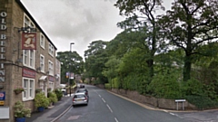 Huddersfield Road at the junction with Gatehead Road in Delph, Oldham. 