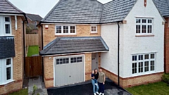 Megan Jones and Phil McGrath with son Harley outside their new home at Saddleworth View