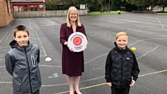 Mrs Milligan proudly shows off St Herberts' award