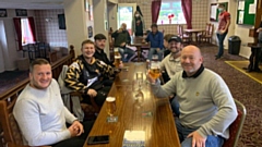 Players and officials at the Delph and Dobcross club toast the return of village cricket