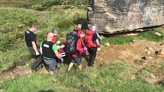 Oldham Mountain Rescue team take the woman to safety