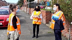 l to r: Alex Birtles, NHS Test and Trace, talking to Arooj Shah, deputy leader of the council, and Debbie Abrahams MP, as they take the Covid safety messages to residents in Clarksfield.