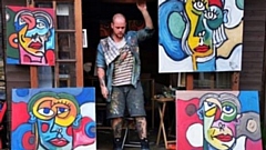 Adam Bromiley-Haslam is pictured with four of his paintings