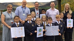 Left to right - Mrs Mostyn (Reception Teacher), Belle, Mr Bowles (TA), Oliver, Nell, Mr Learmont (Head of School), Willow, Amaan, Lottie, Seth, Mr Casey (Y5 Teacher), Elliott, Lilia, Miss Coleman (Y3 Teacher) and Finley