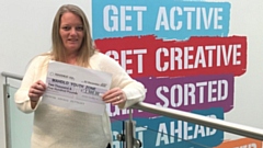 Claire Crossfield, Fundraising Manager at Mahdlo, shows off the cheque