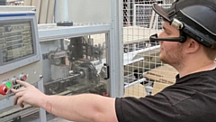 A machine operator testing out handsfree smart glasses. 