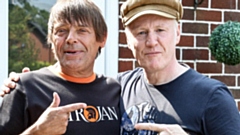 Chris Green is pictured (right) on set with Mani, of Stones Roses fame