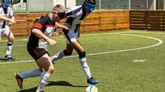 Participants in action playing blind football and goalball