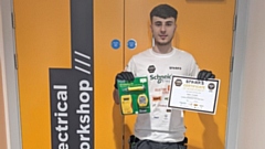 Adam Pitcher with his Certificate of Achievement and prizes from the Spark Grand Final