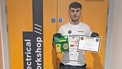 Adam Pitcher with his Certificate of Achievement and prizes from the Spark Grand Final
