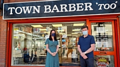 Oldham barber Patrick Scrivens is pictured outside his town centre shop with Christine Khiroya, Screening and Immunisation Lead at the Greater Manchester Health and Social Care Partnership