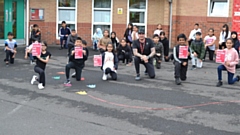 Pupils and staff at Alexandra Park Junior School take a knee, in support of anti-racism. 