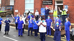 Royal Oldham Hospital staff celebrating a COVID vaccination milestone