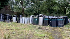 The litter bins being housed in a storage area at Lees cemetery