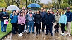 Pictured are MP Debbie Abrahams (centre, with crutches) and Jeremy Sutcliffe (to her left, front row) and the memory walkers at the end of their circuit around Alexandra Park