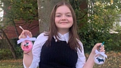 Emily pictured with some examples of her baubles