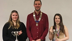 Amy Jakeman and Millie Foster are pictured flanking John Arthurs