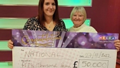 Winner Patricia Lowe (right) and her daughter Kim Rogers are pictured holding the winning cheque