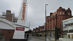 The Prudential Building, seen behind Oldham Central Metrolink stop. 