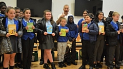 Frank Cottrell-Boyce is pictured with some of the Harmony Trust children