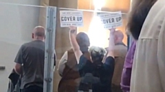 Members of the public waved signs that said 'cover up' at a meeting of the council convened to discuss the findings of the CSE report