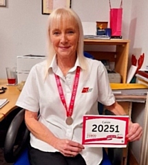 HR Manager Carole Hamnett-Sadler with her Race For Life medal and number.