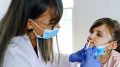 A child receives the nasal flu vaccine