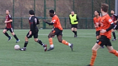 Action from the Division Two clash between Trafford United and AFC Oldham (orange shirts)