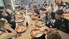 Students tuck into their pizzas in Italy