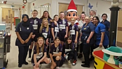 The Santos Sharks under-12s girls' football team party are pictured at the hospital