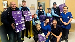 Heyside Football Club players and coaches pictured at the hospital