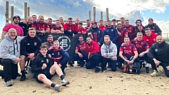 The Roughyeds players and staff take a break during their stint at Farmer Strong. Image courtesy of ORLFC
