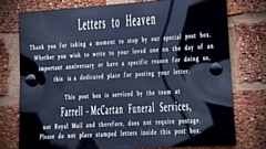 The plaque above the Farrell-McCartan Funeral Service 'Postbox to Heaven'