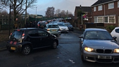 Traffic on the road outside Bare Trees Primary School in Chadderton